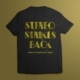 Attitude wear: large 'Stereo Strikes Back' silkscreened in bright yellow on black cotton t-shirt.